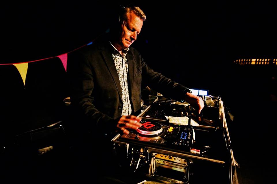 Nick Campbell DJ performing behind the decks